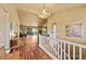 Elegant foyer with hardwood floors, a soaring antler chandelier, and access to multiple living spaces at 39681 Swift Creek Cir, Elizabeth, CO 80107