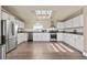 Bright kitchen features stainless steel appliances, ample cabinetry, and a skylight for natural light at 39681 Swift Creek Cir, Elizabeth, CO 80107