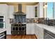 Beautiful kitchen with white cabinets, a large farmhouse sink, and a mosaic tile backsplash at 39681 Swift Creek Cir, Elizabeth, CO 80107