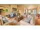 Inviting living room with a stone fireplace, hardwood floors, comfortable seating, and natural light at 39681 Swift Creek Cir, Elizabeth, CO 80107