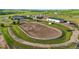 Aerial view of a horse training arena with fences, jumps, and well-manicured landscaping at 39681 Swift Creek Cir, Elizabeth, CO 80107