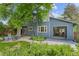 Backyard view showcasing a spacious patio, green lawn, mature trees and lush landscaping at 2201 Juniper Ct, Boulder, CO 80304