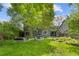 Expansive backyard showcasing a lush lawn, multiple patio areas, mature trees, and verdant landscaping at 2201 Juniper Ct, Boulder, CO 80304
