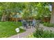 Backyard patio setting features comfortable seating, mature trees, and landscaped surroundings at 2201 Juniper Ct, Boulder, CO 80304