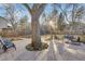 Large backyard with ample seating, mature trees, and a concrete patio perfect for entertaining at 2201 Juniper Ct, Boulder, CO 80304