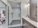 Sleek bathroom featuring a glass enclosed shower, gray tile flooring, and modern fixtures at 2201 Juniper Ct, Boulder, CO 80304