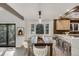 Modern dining area next to the kitchen features a stylish table, upholstered chairs, and bright lighting, perfect for gatherings at 2201 Juniper Ct, Boulder, CO 80304
