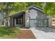Contemporary gray home with distinctive garage door, modern entry, and well-maintained landscaping at 2201 Juniper Ct, Boulder, CO 80304