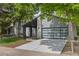 Home exterior featuring a contemporary garage door, neat landscaping, and well-maintained front yard at 2201 Juniper Ct, Boulder, CO 80304