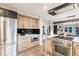 Modern kitchen features stainless appliances, wooden cabinets, stone countertops and an open design at 2201 Juniper Ct, Boulder, CO 80304