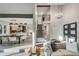 Open-concept living area features high ceilings, modern chandelier, staircase and seamless flow to the dining and kitchen area at 2201 Juniper Ct, Boulder, CO 80304