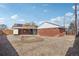 Spacious backyard with gravel, brick exterior, and blue sky at 7180 Zuni St, Denver, CO 80221
