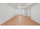 The finished basement has bright walls, recessed lighting, and wood-look flooring for a modern touch at 7180 Zuni St, Denver, CO 80221