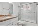 Bathroom features a white vanity, a marble-style tile shower, and updated fixtures at 7180 Zuni St, Denver, CO 80221