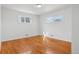 This bedroom features wood floors and two windows, allowing natural light to fill the space at 7180 Zuni St, Denver, CO 80221