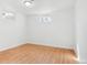Bright bedroom features hardwood floors and natural light from two windows at 7180 Zuni St, Denver, CO 80221