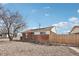 Charming brick home featuring solar panels, a well-maintained lawn and an enclosed yard for privacy at 7180 Zuni St, Denver, CO 80221