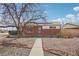 Charming brick home featuring a low-maintenance xeriscaped yard and solar panels on the roof at 7180 Zuni St, Denver, CO 80221