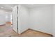 The hallway has light brown tile flooring that extends to another room with hardwood floors at 7180 Zuni St, Denver, CO 80221