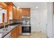 Kitchen featuring stainless steel appliances, wood cabinets, and tile flooring at 7180 Zuni St, Denver, CO 80221
