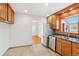 Bright, open kitchen area with tile flooring, stainless steel appliances and plenty of counter space at 7180 Zuni St, Denver, CO 80221