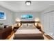 Cozy bedroom with hardwood floors, large window and neutral decor at 7180 Zuni St, Denver, CO 80221