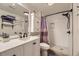 Updated bathroom with a walk-in shower, modern vanity, and stylish fixtures at 5757 S Algonquian Way # E, Aurora, CO 80016