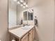Clean bathroom features a bright vanity area with a large well-lit mirror at 10578 Parkington Ln # 35D, Highlands Ranch, CO 80126