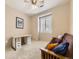 Bedroom features cozy futon and bright natural light from large window at 10578 Parkington Ln # 35D, Highlands Ranch, CO 80126