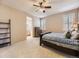 A neutral bedroom with a large bed, shutters on the windows, and carpeted floors at 10578 Parkington Ln # 35D, Highlands Ranch, CO 80126