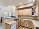 Well-lit kitchen featuring light wood cabinetry and an open layout at 10578 Parkington Ln # 35D, Highlands Ranch, CO 80126