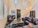 Bright living room featuring a fireplace, high ceilings, large windows, and a comfortable seating area at 10578 Parkington Ln # 35D, Highlands Ranch, CO 80126