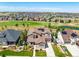 Aerial view of a two-story house with solar panels, situated in a neighborhood near a golf course at 7609 S Country Club Pkwy, Aurora, CO 80016