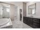 Spa-like bathroom with marble tile, a large shower, and a soaking tub at 7609 S Country Club Pkwy, Aurora, CO 80016