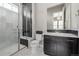 Modern bathroom with a walk-in shower and dark vanity at 7609 S Country Club Pkwy, Aurora, CO 80016