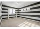 Bedroom with dark and white striped walls and window at 7609 S Country Club Pkwy, Aurora, CO 80016