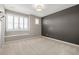 Bedroom with window seat and a dark accent wall at 7609 S Country Club Pkwy, Aurora, CO 80016