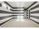 Bedroom with dark and white striped walls and window at 7609 S Country Club Pkwy, Aurora, CO 80016