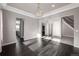 Bright dining room with dark hardwood floors and elegant chandelier at 7609 S Country Club Pkwy, Aurora, CO 80016