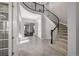 Elegant entryway with a curved staircase and tile flooring at 7609 S Country Club Pkwy, Aurora, CO 80016