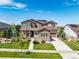 Two-story house exterior, showcasing a stone facade, landscaping, and a driveway at 7609 S Country Club Pkwy, Aurora, CO 80016