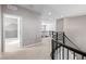 Upstairs hallway with carpet and a view of a bedroom and a staircase at 7609 S Country Club Pkwy, Aurora, CO 80016