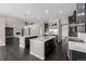 Modern kitchen featuring dark cabinetry, quartz countertops, and stainless steel appliances at 7609 S Country Club Pkwy, Aurora, CO 80016