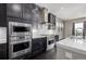 Modern kitchen with stainless steel appliances and dark wood cabinets at 7609 S Country Club Pkwy, Aurora, CO 80016