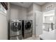 Laundry room with side-by-side washer and dryer at 7609 S Country Club Pkwy, Aurora, CO 80016