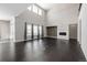 Two-story living room with fireplace and large windows at 7609 S Country Club Pkwy, Aurora, CO 80016