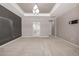 Main bedroom with carpet, access to the bathroom, and a modern light fixture at 7609 S Country Club Pkwy, Aurora, CO 80016