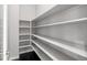 Walk-in pantry offers ample shelving for storage at 7609 S Country Club Pkwy, Aurora, CO 80016