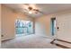 Bright bedroom featuring a ceiling fan and a sliding glass door to a balcony at 8416 Pebble Creek Way # 203, Highlands Ranch, CO 80126