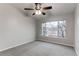Bright bedroom features a ceiling fan and large window allowing ample natural light at 8416 Pebble Creek Way # 203, Highlands Ranch, CO 80126
